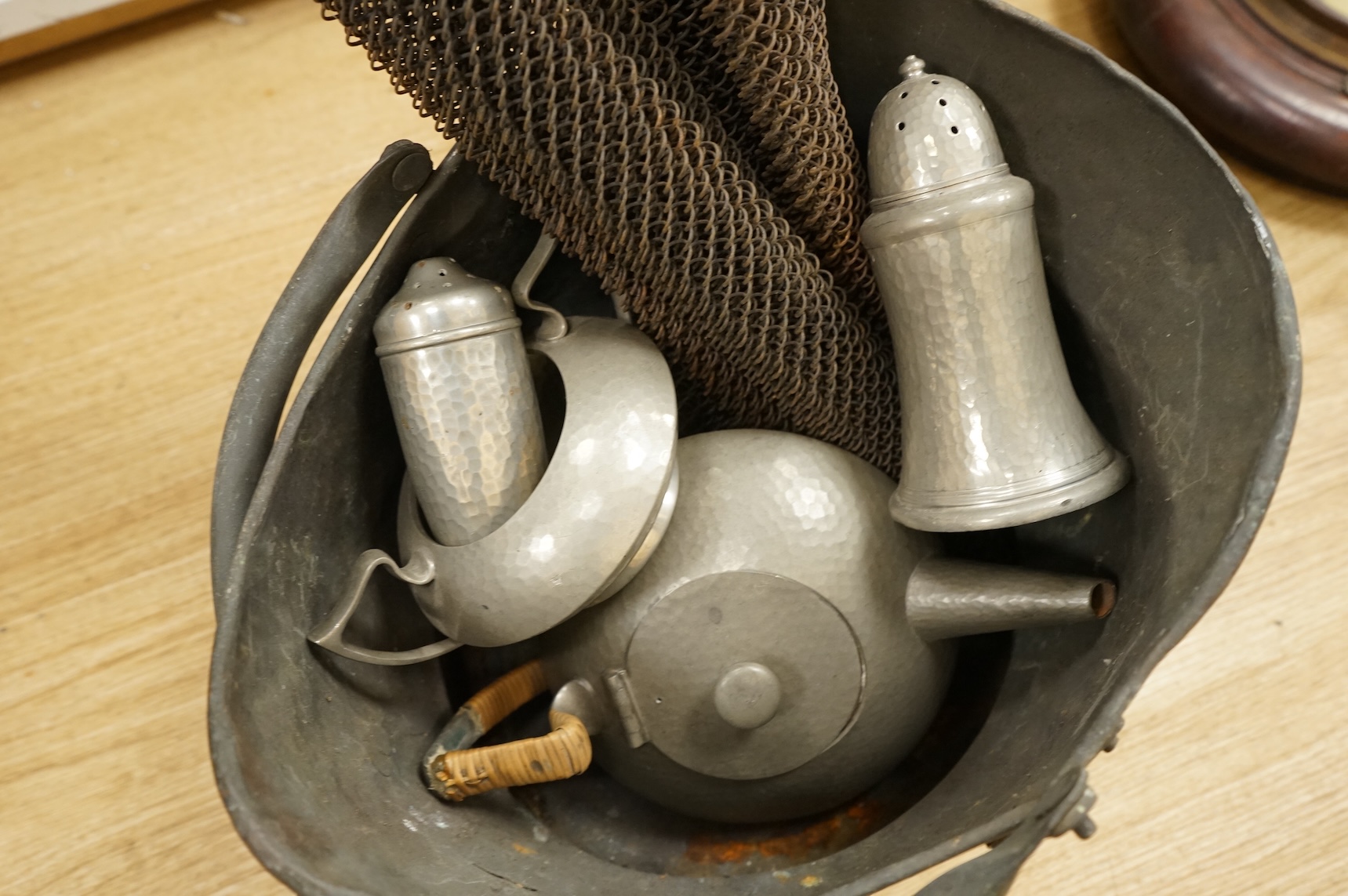 A Hutton, Sheffield English Pewter tea set comprising a teapot, 8cm high, jug and sugar bowl, together with salt and pepper shakers by other makers, a copper coal scuttle and two American mesh fire screens, coal scuttle